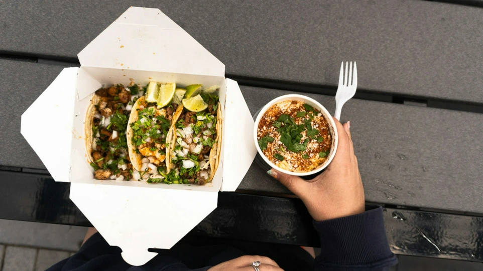 Three tacos and a bowl of food on a table